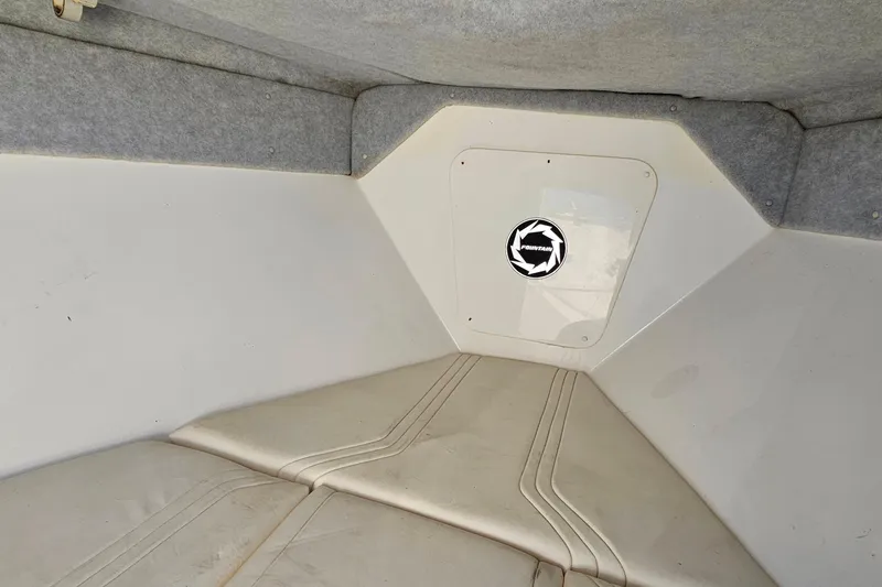 Slide: The Image of Interior cabin of a 1996 Fountain 31 Tournament Edition boat, featuring cushioned seating. - 36