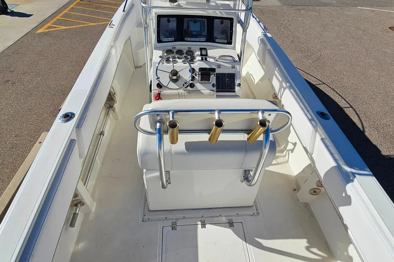 Slide: The Image of 1996 Fountain 31 Tournament Edition boat interior with steering console and rod holders. - 35