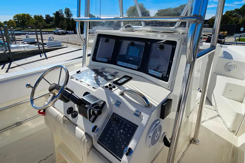 Slide: The Image of 1996 Fountain 31 Tournament Edition boat console with steering wheel and navigation equipment. - 17