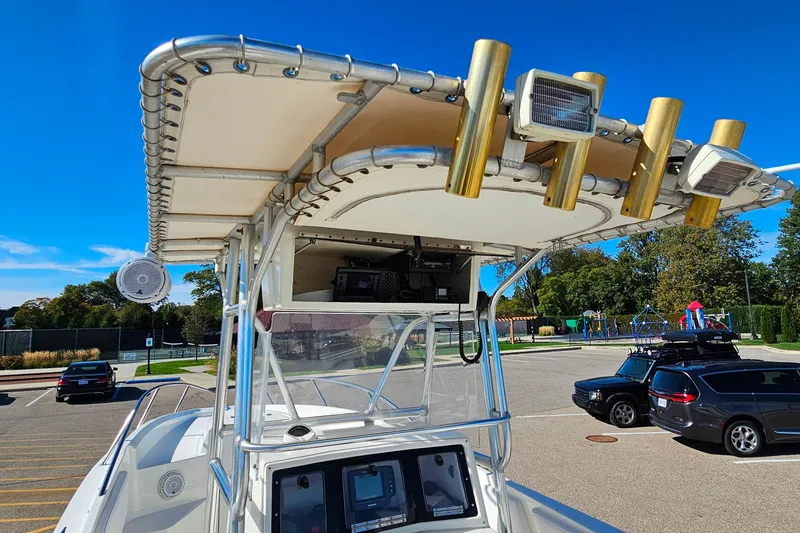 Slide: The Image of 1996 Fountain 31 Tournament Edition boat with T-top and rod holders in a parking lot. - 33