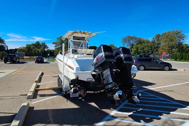 Slide: The Image of 1996 Fountain 31 Tournament Edition boat with dual Mercury engines in a parking lot. - 9