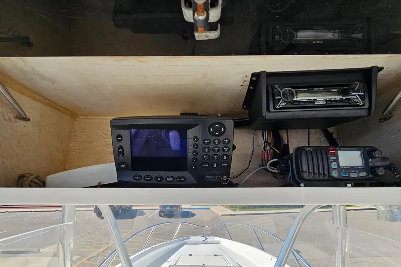 Slide: The Image of 1996 Fountain 31 Tournament Edition boat dashboard with navigation and communication equipment. - 20