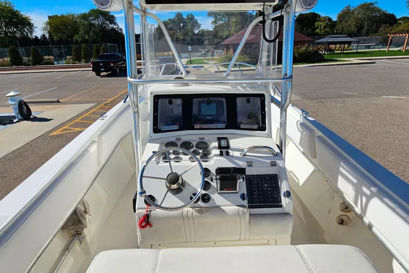 Slide: The Image of 1996 Fountain 31 Tournament Edition boat dashboard with steering wheel and controls. - 16