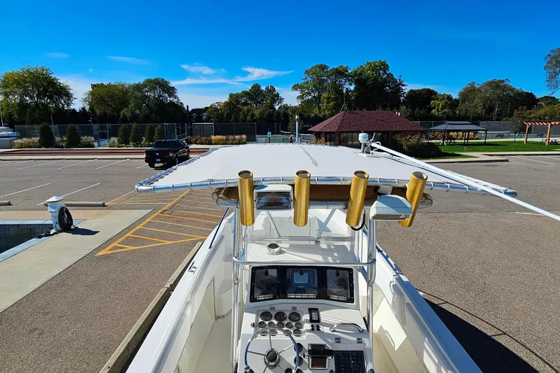 Slide: The Image of 1996 Fountain 31 Tournament Edition boat with fishing rod holders, parked in a sunny lot. - 34