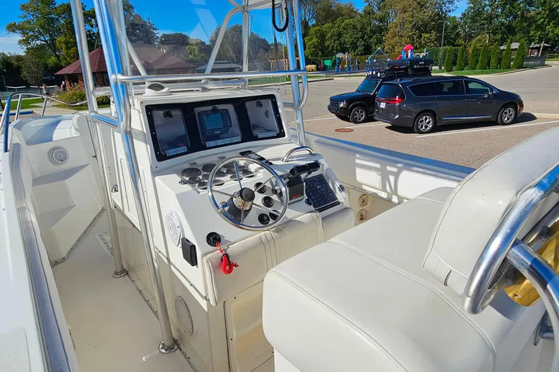 Slide: The Image of 1996 Fountain 31 Tournament Edition boat cockpit with steering wheel and control panel. - 18