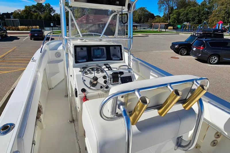 Slide: The Image of 1996 Fountain 31 Tournament Edition boat interior with steering wheel and rod holders. - 14