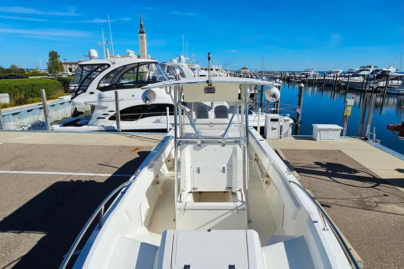 Slide: The Image of 1996 Fountain 31 Tournament Edition boat docked at a marina with clear blue skies. - 29