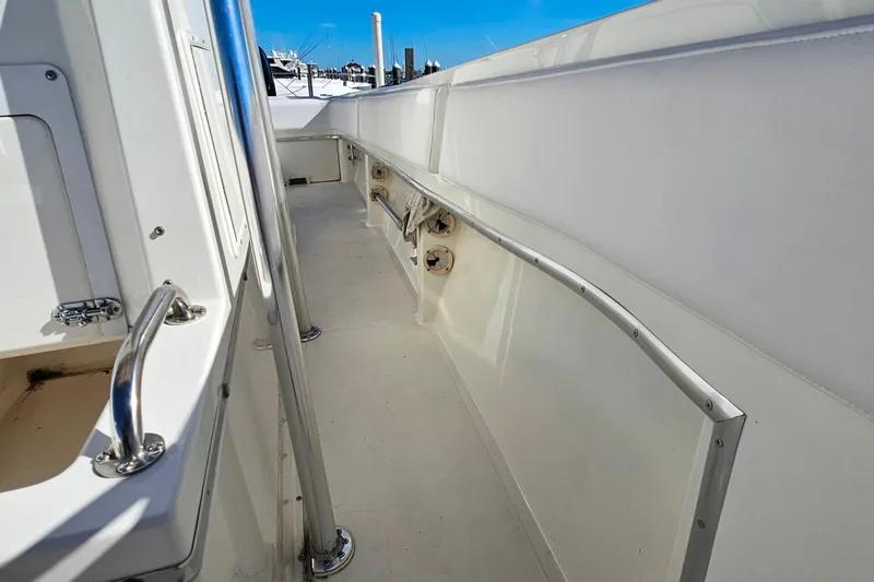 Slide: The Image of 1996 Fountain 31 Tournament Edition boat deck with stainless steel railings and white interior. - 25