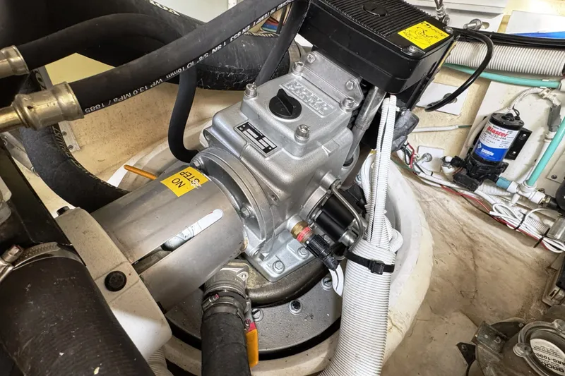 Slide: The Image of Engine compartment of a 2008 Tiara Yachts 4300 Sovran, showcasing mechanical components and hoses. - 41