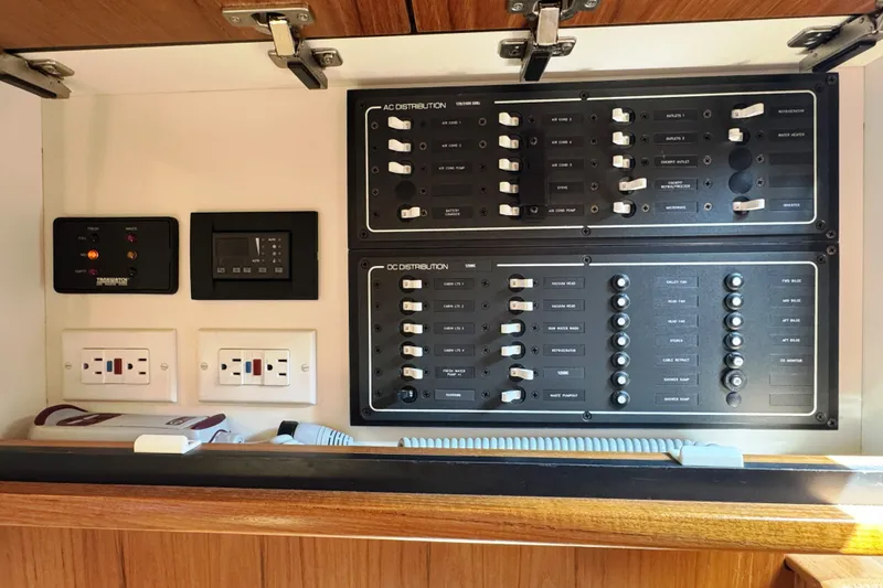 Slide: The Image of Electrical control panel inside 2008 Tiara Yachts 4300 Sovran, featuring AC and DC distribution. - 36
