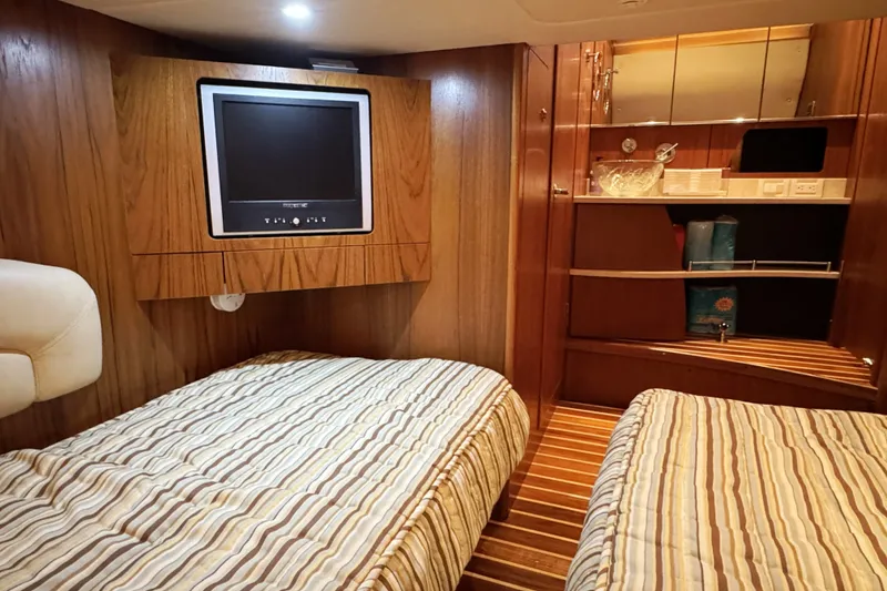 Slide: The Image of 2008 Tiara Yachts 4300 Sovran cabin with twin beds and built-in TV. - 33