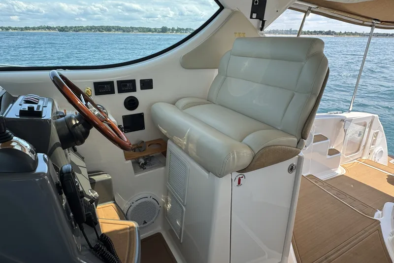 Slide: The Image of Helm of 2008 Tiara Yachts 4300 Sovran with leather seat and wooden steering wheel. - 14