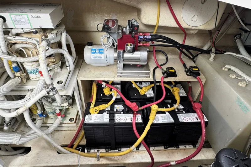 Slide: The Image of Engine room of a 2008 Tiara Yachts 4300 Sovran, showcasing batteries and wiring. - 44