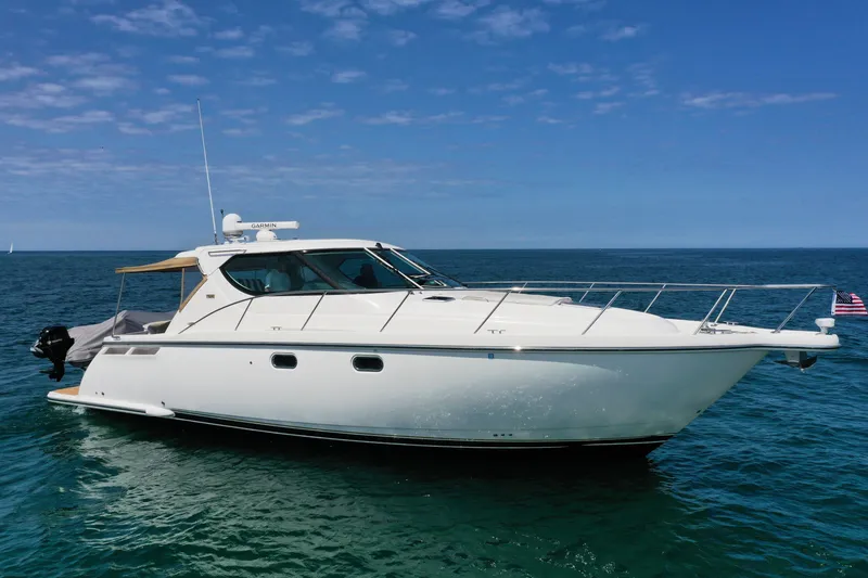 Slide: The Image of 2008 Tiara Yachts 4300 Sovran cruising on open water under a clear blue sky. - 1