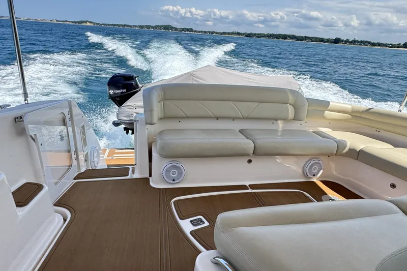 Slide: The Image of 2008 Tiara Yachts 4300 Sovran cruising on open water, featuring spacious seating and elegant design. - 8