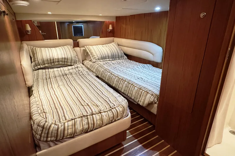 Slide: The Image of Interior cabin of 2008 Tiara Yachts 4300 Sovran with twin beds and wood paneling. - 32