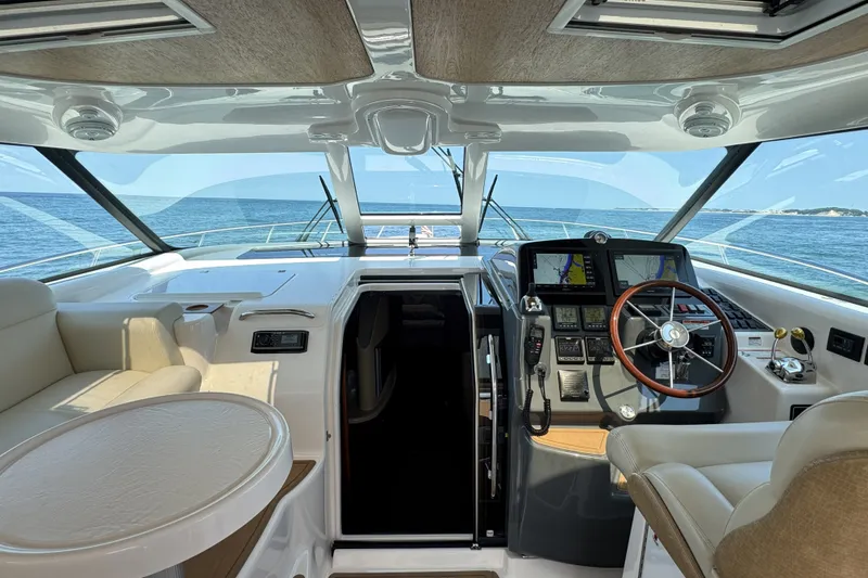 Slide: The Image of 2008 Tiara Yachts 4300 Sovran helm with ocean view, featuring modern navigation equipment. - 15