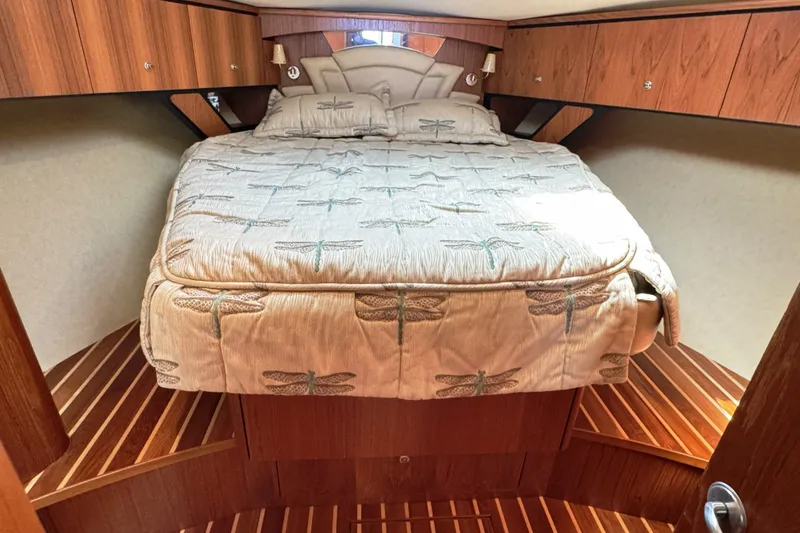 Slide: The Image of Luxurious cabin interior of 2008 Tiara Yachts 4300 Sovran with dragonfly-themed bedding. - 27
