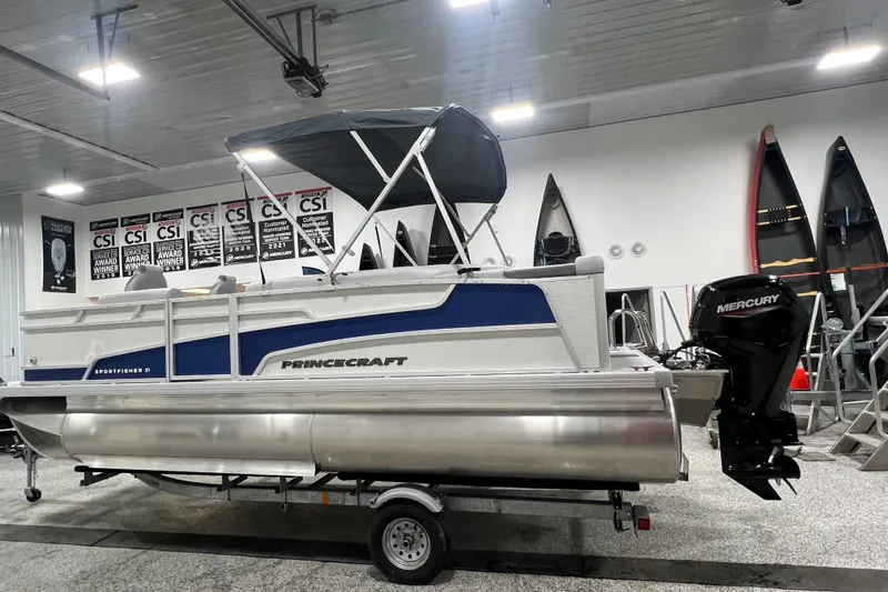 Slide: The Image of 2025 Princecraft Sportfisher 21-2S pontoon boat with Mercury engine in showroom. - 4