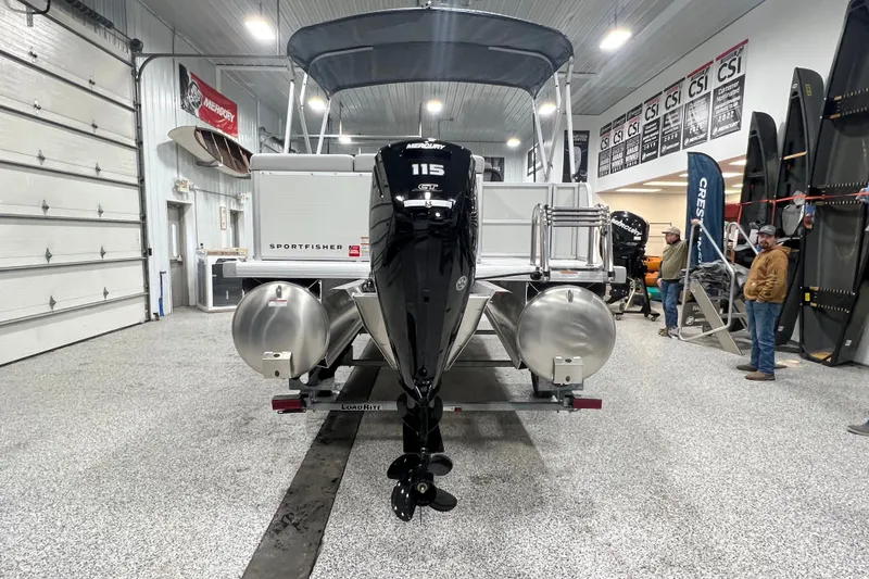Slide: The Image of 2025 Princecraft Sportfisher 21-2S pontoon boat in showroom with Mercury outboard motor. - 8