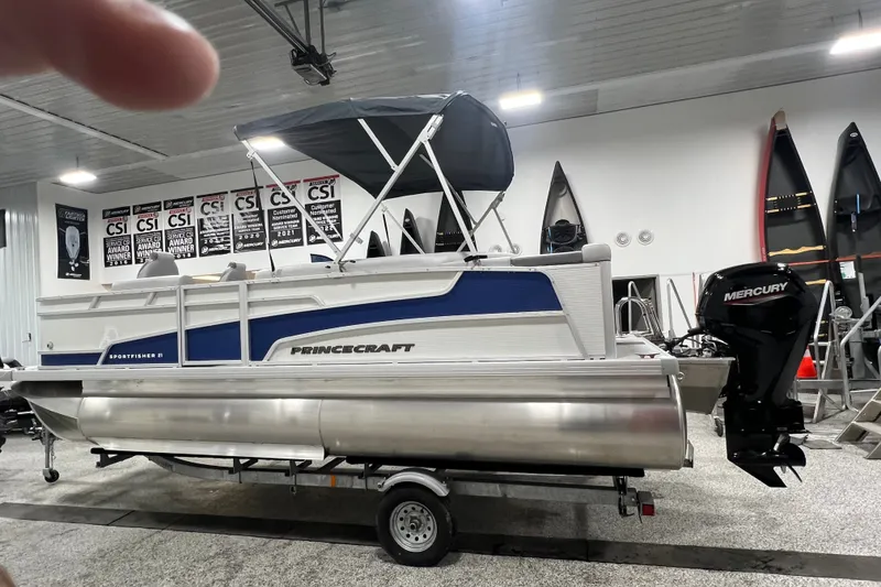 Slide: The Image of 2025 Princecraft Sportfisher 21-2S pontoon boat with Mercury engine in showroom. - 3