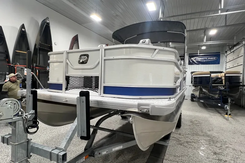 Slide: The Image of 2025 Princecraft Sportfisher 21-2S pontoon boat in a showroom, front view. - 7