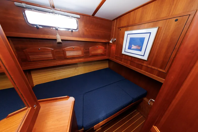 Slide: The Image of Cozy cabin interior of 2006 Sabre 42 Hard Top Express with wooden finish and blue bedding. - 38