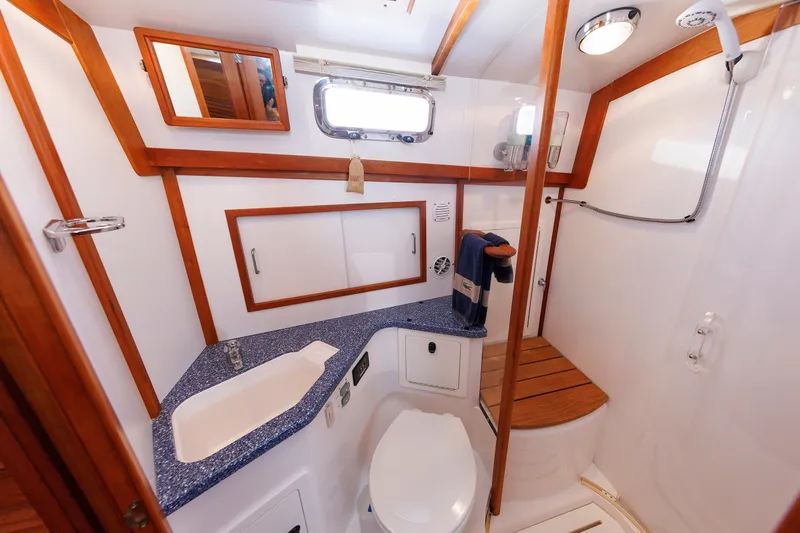 Slide: The Image of Luxurious bathroom in 2006 Sabre 42 Hard Top Express yacht, featuring modern fixtures and wood accents. - 43