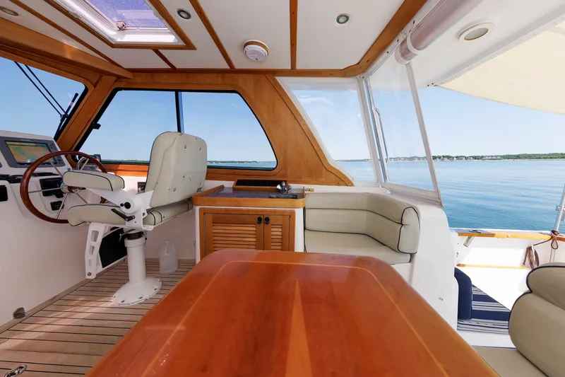 Slide: The Image of Interior of 2006 Sabre 42 Hard Top Express yacht with helm, seating, and ocean view. - 24