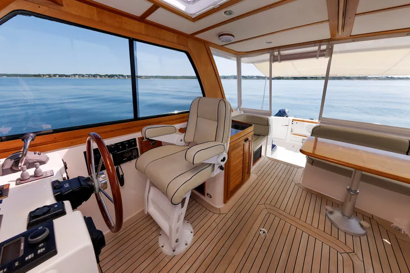 Slide: The Image of 2006 Sabre 42 Hard Top Express interior with helm, seating, and ocean view. - 25
