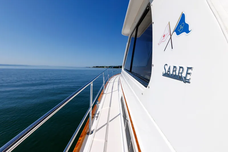 Slide: The Image of 2006 Sabre 42 Hard Top Express yacht cruising on calm blue waters. - 45