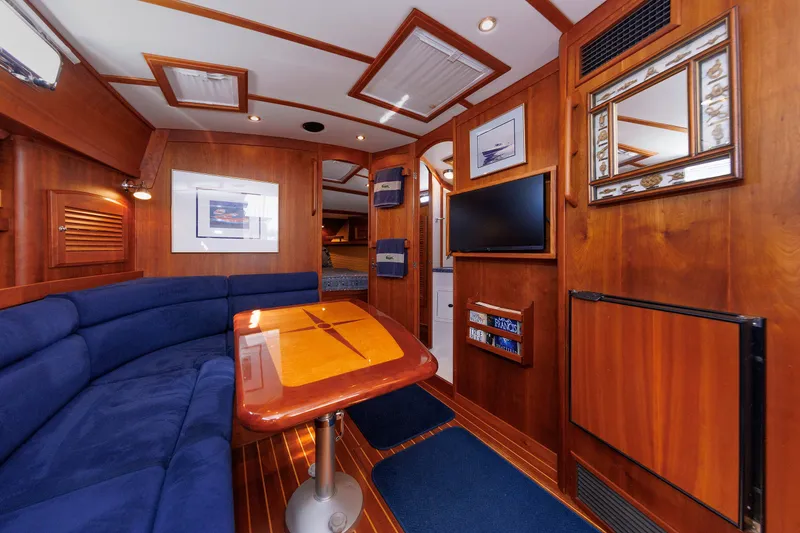 Slide: The Image of Luxurious interior of 2006 Sabre 42 Hard Top Express yacht with wood finish and blue seating. - 35