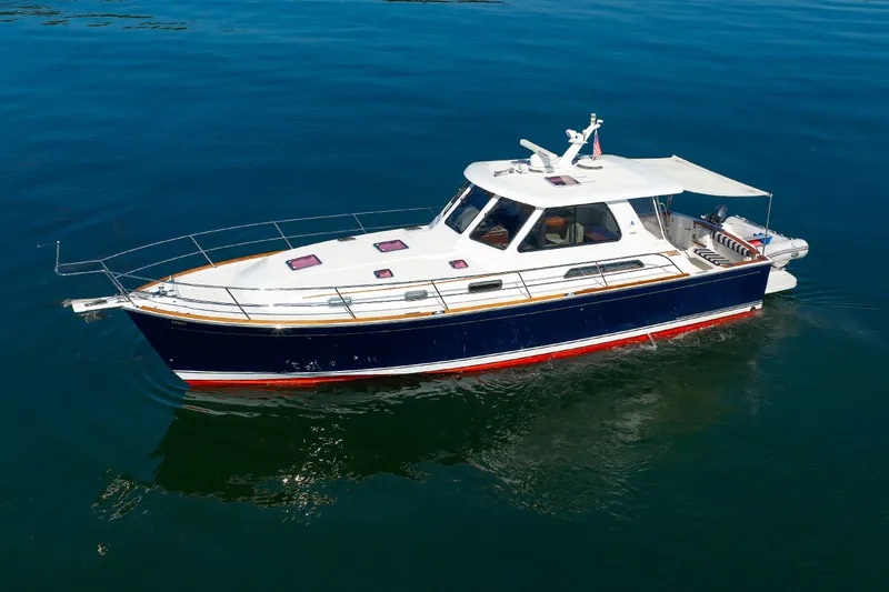 Slide: The Image of 2006 Sabre 42 Hard Top Express boat on calm blue water. - 4