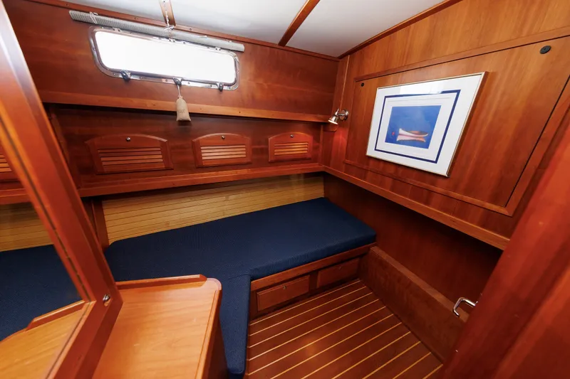 Slide: The Image of 2006 Sabre 42 Hard Top Express cabin with wooden interior and blue cushioned seating. - 37
