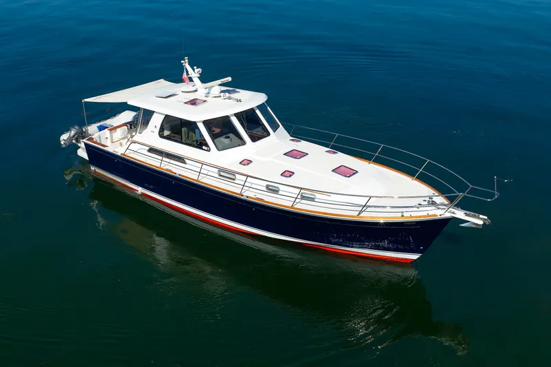 Slide: The Image of 2006 Sabre 42 Hard Top Express yacht on calm blue water. - 5