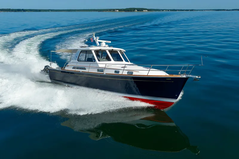 The Image of 2006 Sabre 42 Hard Top Express cruising on calm blue waters. - 1
