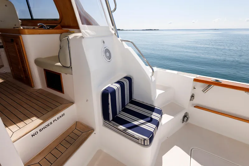 Slide: The Image of 2006 Sabre 42 Hard Top Express yacht interior with striped seating and ocean view. - 15