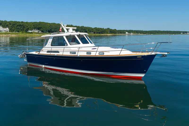 Slide: The Image of 2006 Sabre 42 Hard Top Express yacht on calm water, clear sky background. - 10