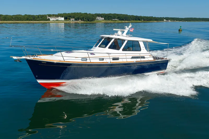 Slide: The Image of 2006 Sabre 42 Hard Top Express cruising on calm waters, showcasing sleek design and performance. - 2