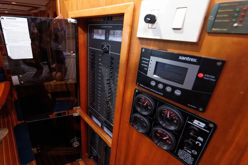 Slide: The Image of Electrical control panel inside 2006 Sabre 42 Hard Top Express yacht, featuring gauges and switches. - 52