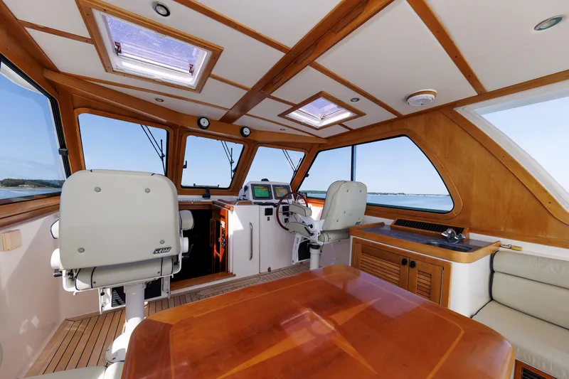 Slide: The Image of Interior of 2006 Sabre 42 Hard Top Express yacht with helm and seating area. - 27