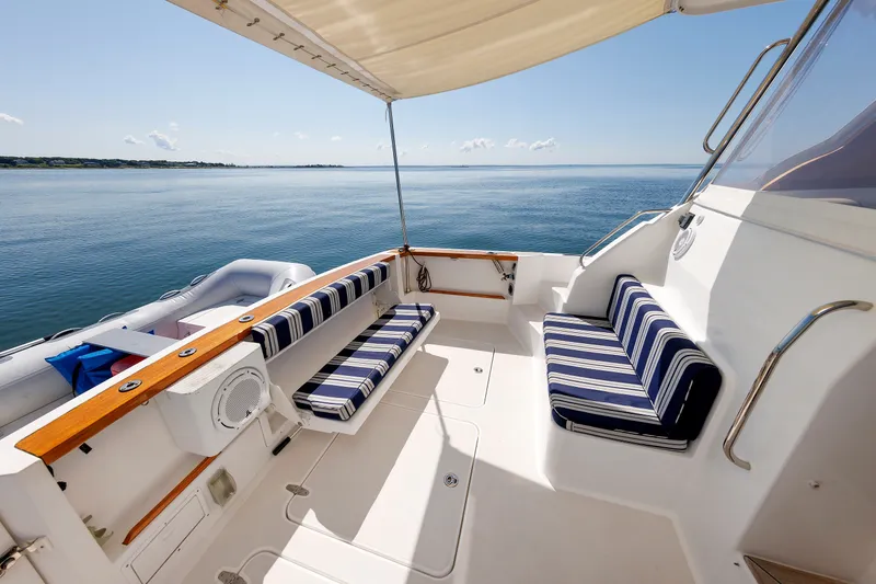 Slide: The Image of Luxurious 2006 Sabre 42 Hard Top Express yacht with striped seating, ocean view. - 14