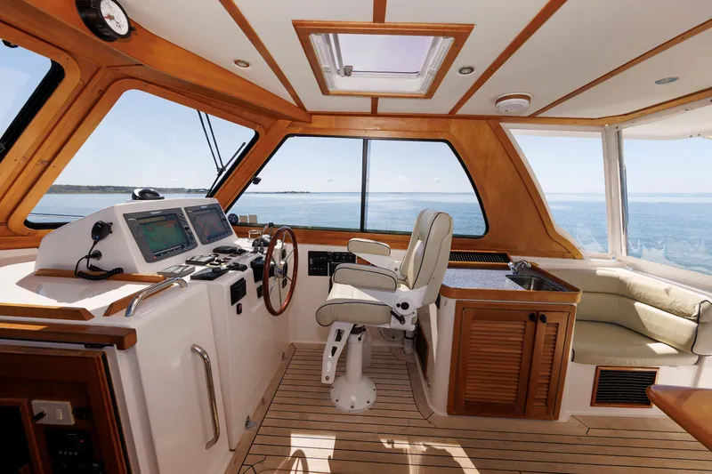 Slide: The Image of Interior of 2006 Sabre 42 Hard Top Express yacht with helm and seating area. - 26