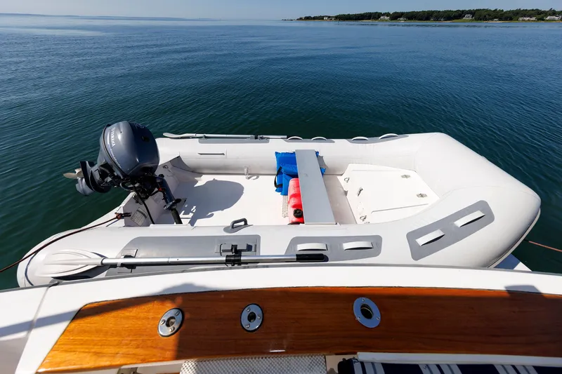 Slide: The Image of Inflatable boat with motor on Sabre 42 Hard Top Express, 2006, in calm waters. - 59