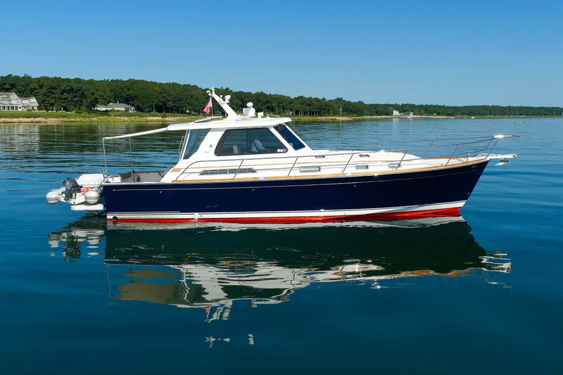 Slide: The Image of 2006 Sabre 42 Hard Top Express yacht on calm water, clear sky background. - 11