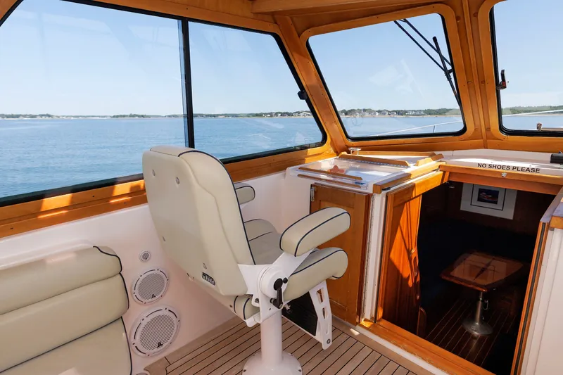 Slide: The Image of Interior view of 2006 Sabre 42 Hard Top Express yacht with helm seat and ocean view. - 22