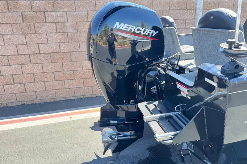 Slide: The Image of 2022 Tracker Pro Guide V-175 Combo with Mercury outboard motor, parked outdoors. - 6