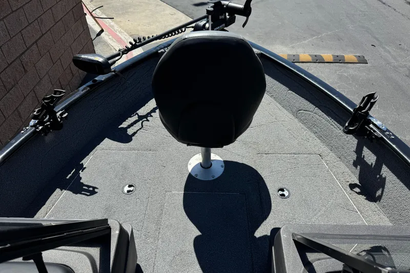 Slide: The Image of 2022 Tracker Pro Guide V-175 Combo boat interior with seating and fishing rod holders. - 13