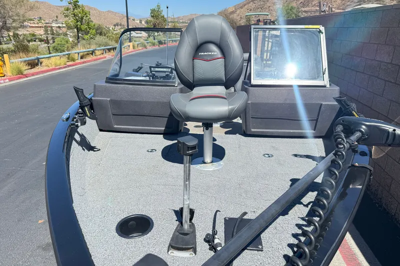 Slide: The Image of 2022 Tracker Pro Guide V-175 Combo boat with seating and fishing equipment on deck. - 10