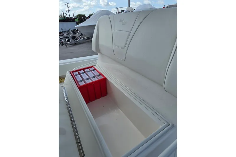 Slide: The Image of 2023 SeaVee 340B boat storage compartment with red tackle boxes. - 12